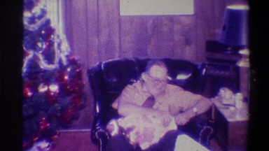 1973: a man opening his gift on christmas morning. NEW YORK