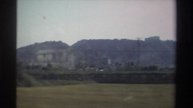 1982: A Slight Reflection on the Window of a Vehicle as It Rides Through a Rural Taiwanese Neighborhood