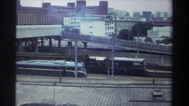 1982: a passenger train rides down the tracks in a city TAIWAN