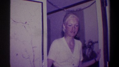 1973: A Pretty Smiling Lady Plays With the Camera as She Poses and Hides
