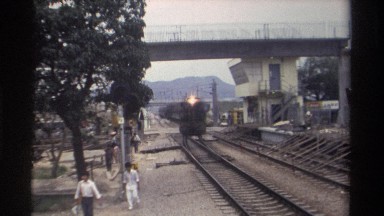 1982: passenger train heading towards the camera with a few people walking to