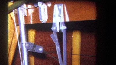 1964: Flat Silver Metal Strips with White Rollers Connected by Screws