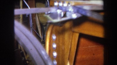 1964: connected rods form metal frame attached to wooden structure in cluttered