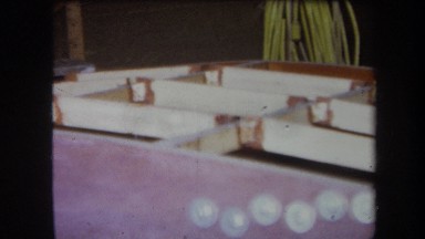 1964: wooden structure that is incomplete and with a black metal attachment
