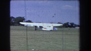 1965: watching a test flight of a small aircraft on a sunny day in the airfield