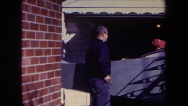 1969: two men examine a partially built homemade aircraft parked in a home's