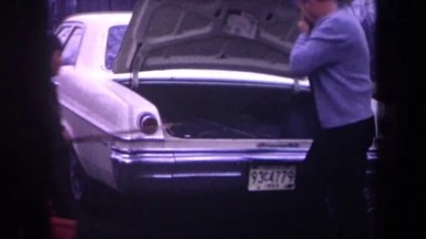 1968: Father and Two Sons Prep for Fishing Trip in Michigan