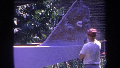 1969: man spray paints defaced public area for charity in the neighborhood