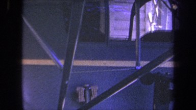 1969: A panning view of a blue plane with a singular white stripe named N2228
