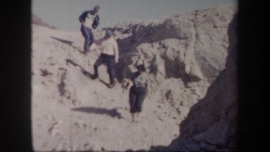 1957: A Group of People Carefully Going Down a Sandy Slope Arizona