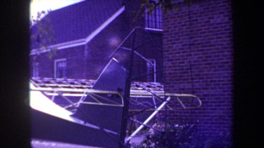 1969: Pan over an incomplete airplane fuselage in a residential backyard near Volmer Yucaipa California