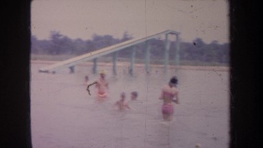 1968: adults and children enjoying their time bathing in a lake. MICHIGAN