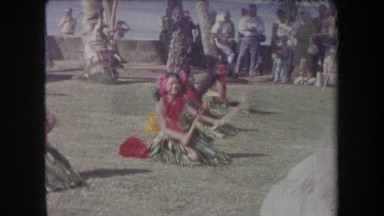 1969: hawaiian dancers performing with sticks on a beach for an audience HAWAII