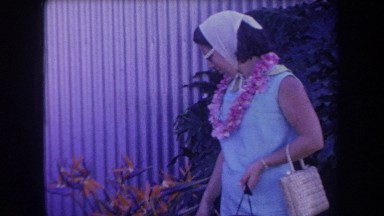 1969: a woman looking at flowers HAWAII