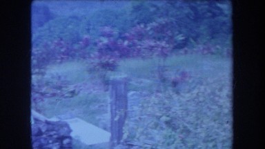 1969: poorly lit panoramic of a cemetery and an adjacent building HAWAII