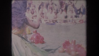1969: a hawaiian luau with girl playing drums while people are watching HAWAII