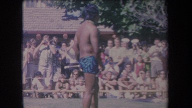 1969: man doing a performance with two swords in front of a large audience