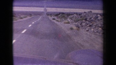 1958: driving quickly on a long desolate highway ARIZONA