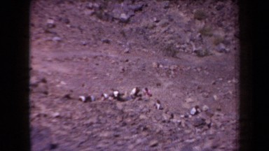 1958: numerous people working among stones on an arid mountain ARIZONA