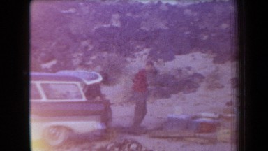 1958: a group of young men take stock of their belongings in a natural setting