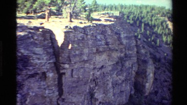 1980: Rock Cliff and Adjacent Steep Slopes with Forest Background