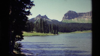 1980: beautiful wide river flowing past a landscape of greenery and trees and