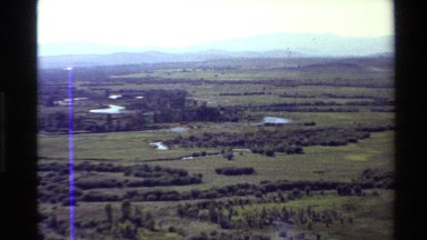 1980: an aerial view of a rural area with a meandering river snaking through