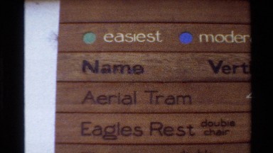 1980: sign with ski lift directory spelling out lift name, elevation and