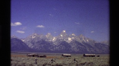 1980: buildings in a valley with hills and peaks in the background WESTERN USA