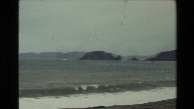 1981: The Waves of the Sea from a Beach with Rocks in the Distance New Zealand