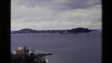 1981: a large ship heading out to sea on a cloudy day NEW ZEALAND
