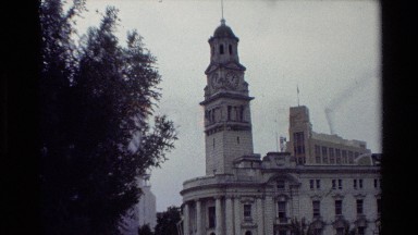 1981: people sitting around the water out in front of a historic building NEW