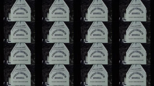 1981: One Large Ship Docked on Water as Smaller Boats Approach