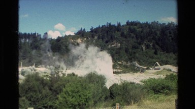 1981: a geyser puffing out billows of smoke in the forested wilderness NEW