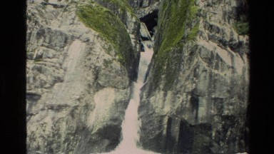 1982: a waterfall on a rocky mountain being climbed by a party NEW ZEALAND