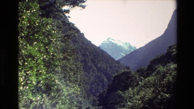 1982: camera zooms in on a distant mountain top. NEW ZEALAND