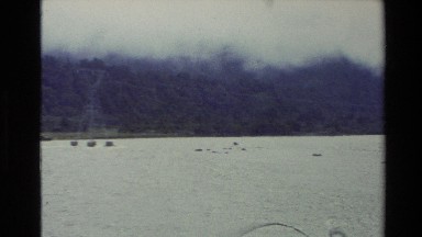 1982: panoramic view of a deltaic area with mountains adjacent and stream water