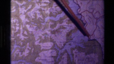 1982: a pointer tracing a body of water on a map NEW ZEALAND
