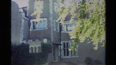 1982: panning shot of a beautiful brown brick building with many windows NEW