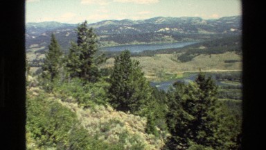 1980: one lake around the mountain and the full of green big trees GRAND TETON