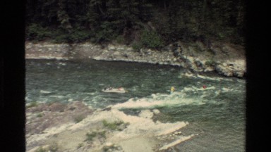1980: Kayakers and Rafter Riding Whitewater River in Grand Teton Wyoming
