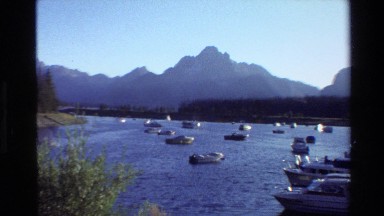 1980: dozens of boats anchored in a reservoir with jagged peaks in the distance