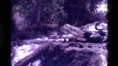 1980: cascading waterfalls that have boulders and wood and progress in a