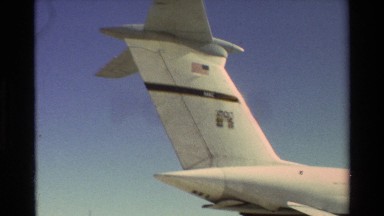 1981: Military Plane Sitting Peacefully on Tarmac with Crew Nearby Having a Discussion
