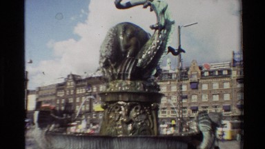1982: A Fountain Viewed From the Street in the Middle of a Square Surrounded by Buildings