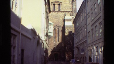 1982: a very tall building on the street which has a tomb like structure on its