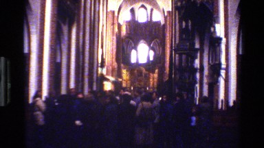 1982: view of visitors milling around in large, old, probably catholic church