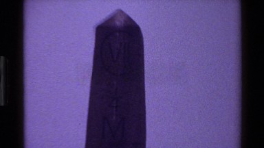 1983: a tall concrete monument has roman numerals carved in the surface DENMARK