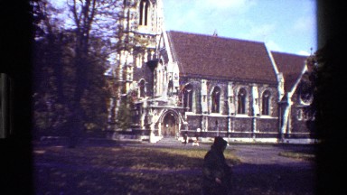 1983: men passing by side of a church. DENMARK