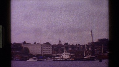 1983: a close up of a windmill along other buildings DENMARK